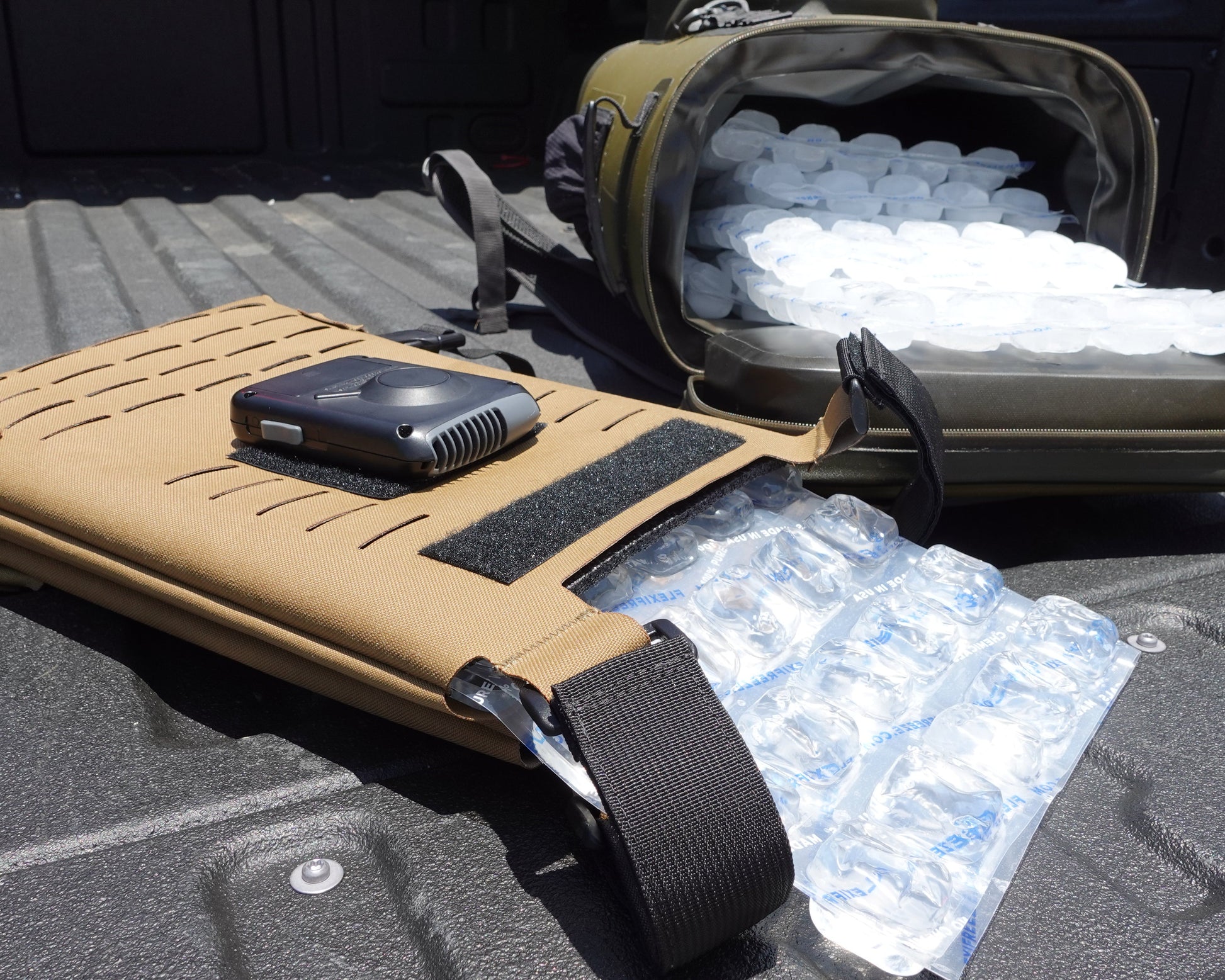 A Cooling Vest in the back of a truck with replacement ice packs. 